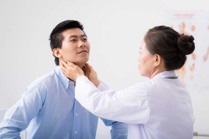 Female physician examining a man’s lymph nodes