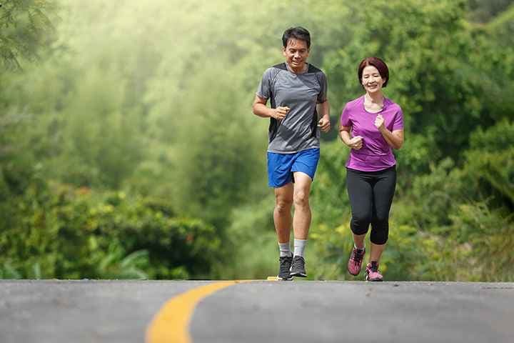 Middle-aged couple jog outdoors