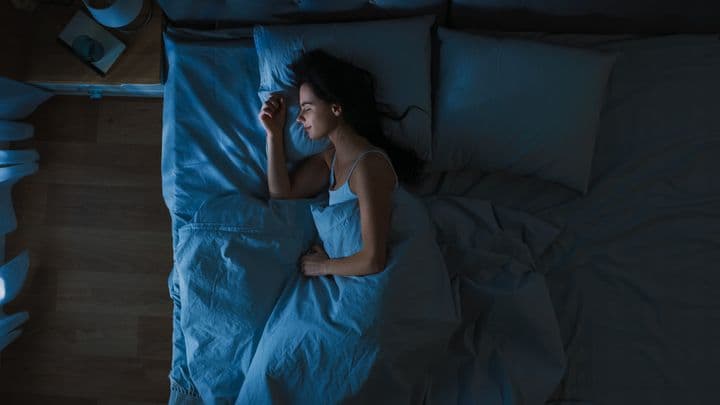 Top view of a woman sleeping on her right side 