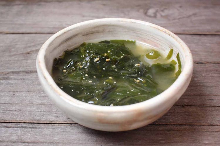 One portion of Korean seaweed soup in a ceramic bowl