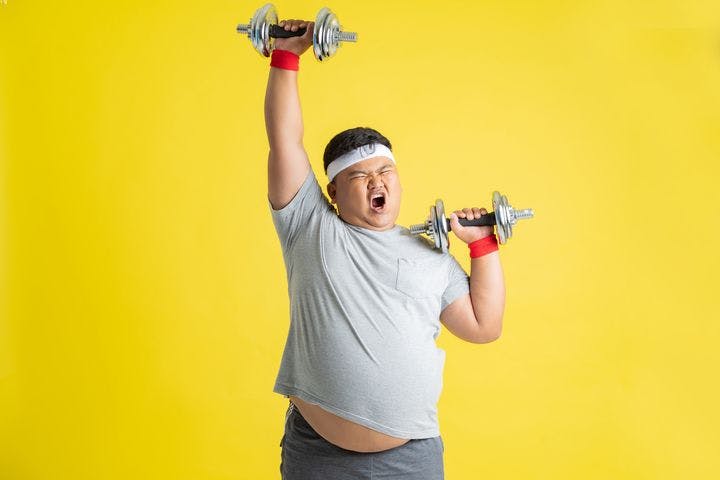 Man with excessive weight lifting a dumbbell into the air with his right hand