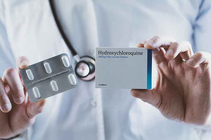 Doctor holding a box of hydroxychloroquine tablets