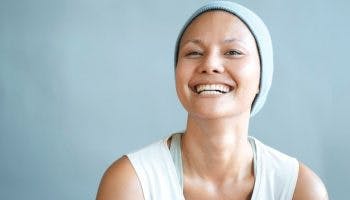Woman wearing a baby blue-coloured beanie and smiling