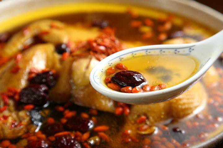 Chinese herbal soup on a spoon