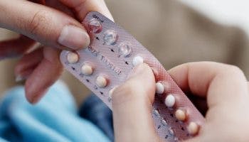 A woman taking a daily birth control pill