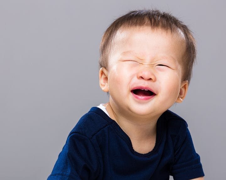  Boy blinking his eyes while smiling