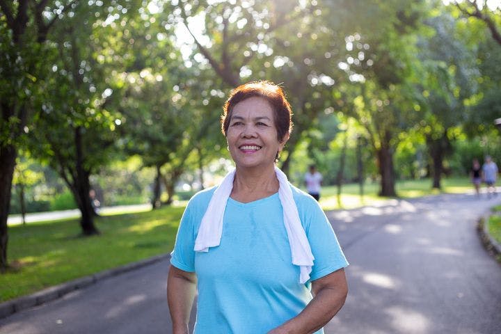 Woman walking in the park and smiling