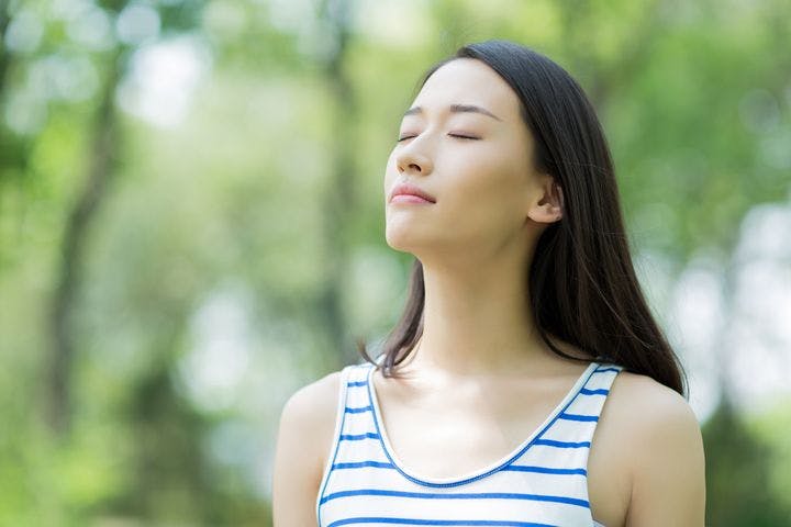 Woman breathing fresh air outdoors