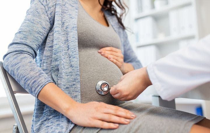 Pregnant woman getting her unborn baby checked up by a doctor