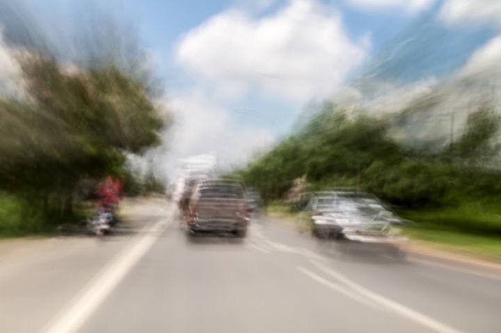 Point-of-view of a person experiencing blurred and double vision while driving