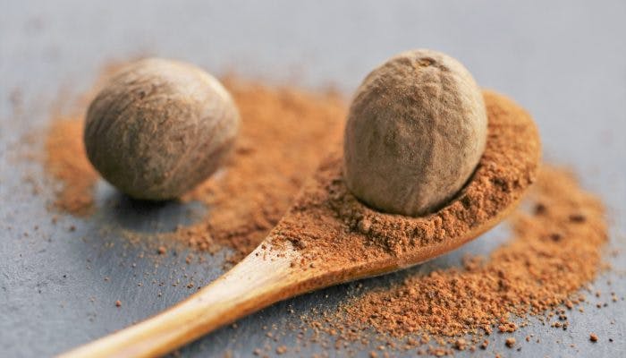Close up of nutmeg fruit and nutmeg powder