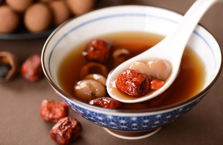 Chinese herbal soup with red jujubes and longan in a bowl