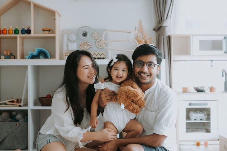 Close-up family picture of Suet Lee, Karthik, and their daughter Maya