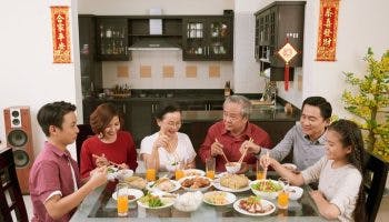 Extended family enjoys a Chinese New Year dinner together at home.