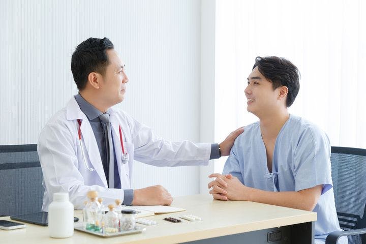 Male doctor and young male patient