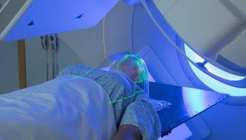 Woman lying face up while undergoing radiation therapy
