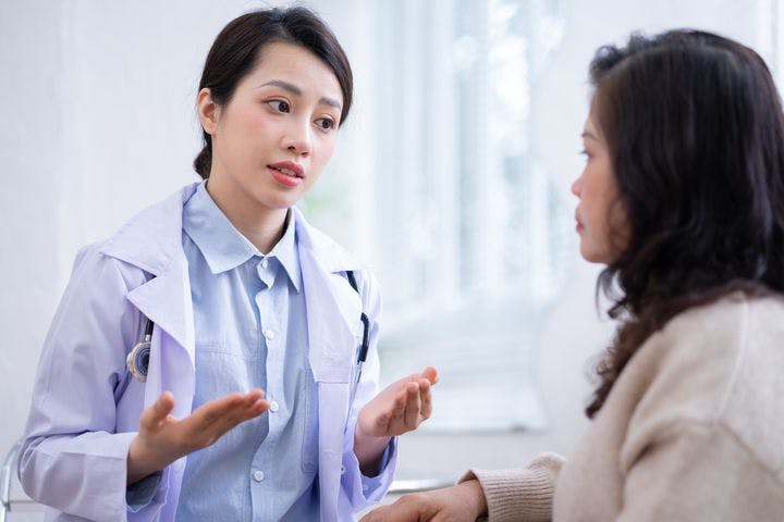 Doctor speaking to an older woman who is a patient.
