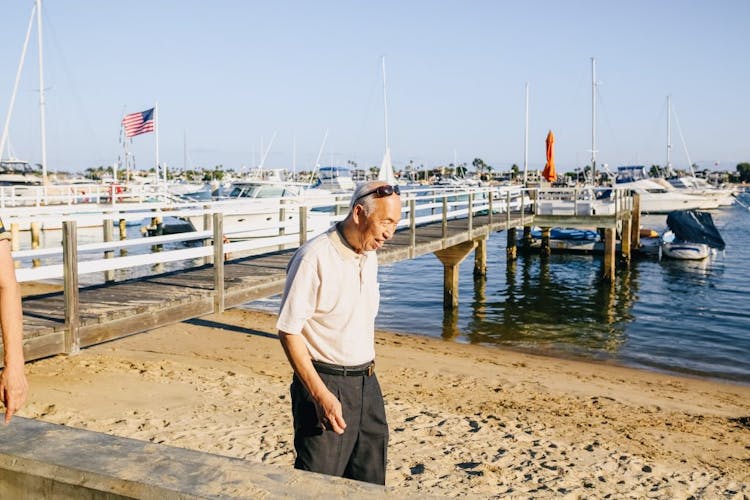 An old man taking a walk near the jetty