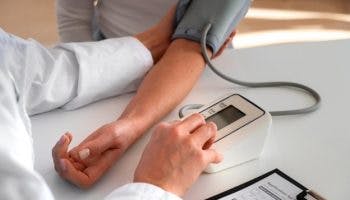 Doctor checking blood pressure of patient