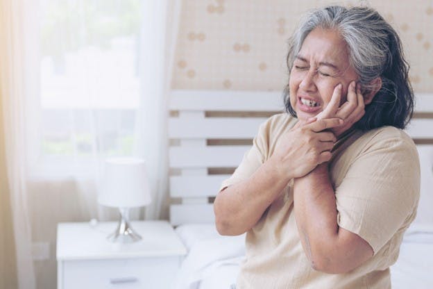 Senior women in pain for having swollen gum problem