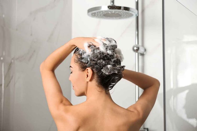 Woman washing her hair in the shower