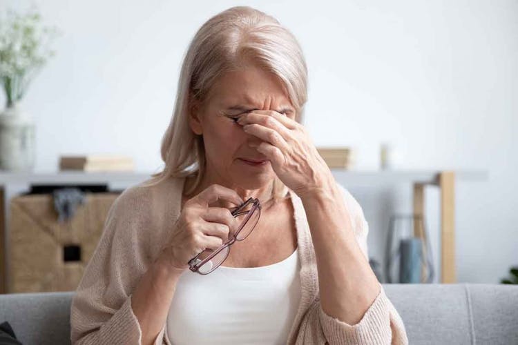 Elderly woman massaging her eyes to relieve discomfort