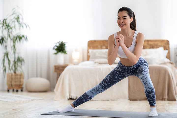 Woman doing a side lunge on a yoga mat