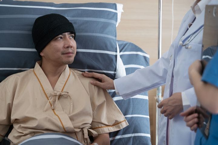 Middle-aged Asian man on a hospital bed 