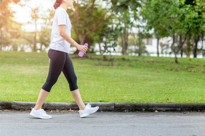Woman in exercise wear walking outside on the street