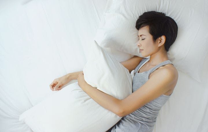 Woman sleeping soundly in her bed