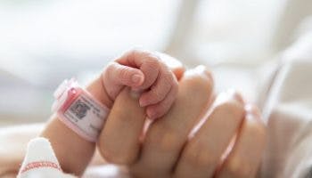 Premature baby holding to its mother’s finger