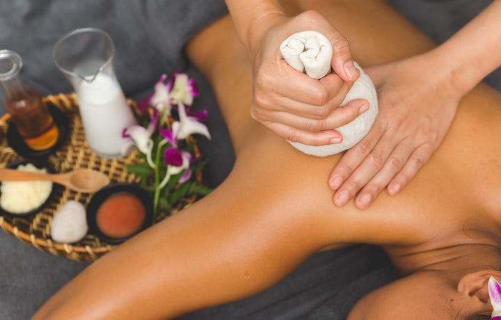 Woman having a massage with a herbal massage ball