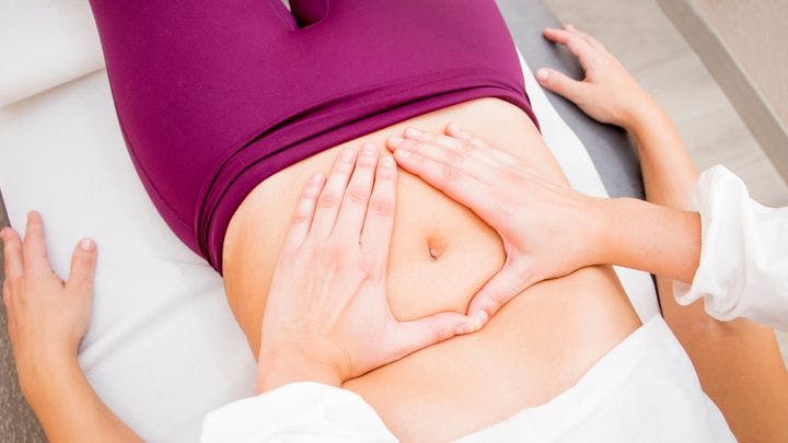 Woman receiving abdominal massage 