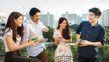 A group of young people drinking beverages on a rooftop