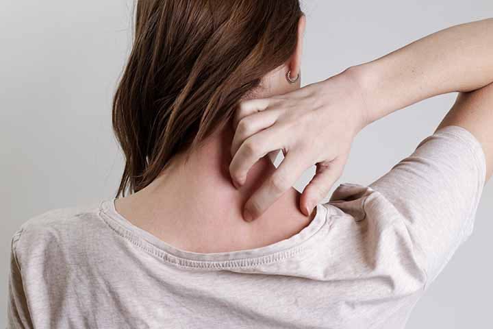Woman scratching the back of her neck