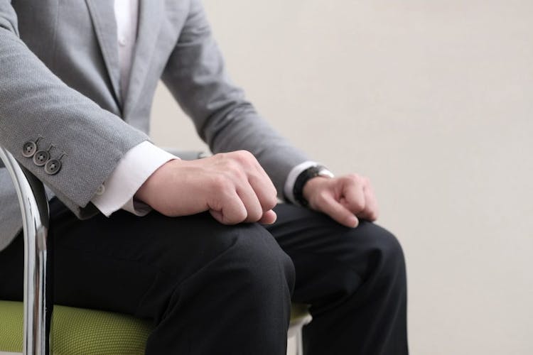 Image of a nervous man's clenched fists during a job interview