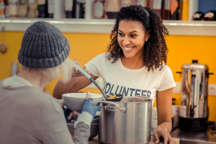 A young woman volunteering at a soup kitchen for the homeless