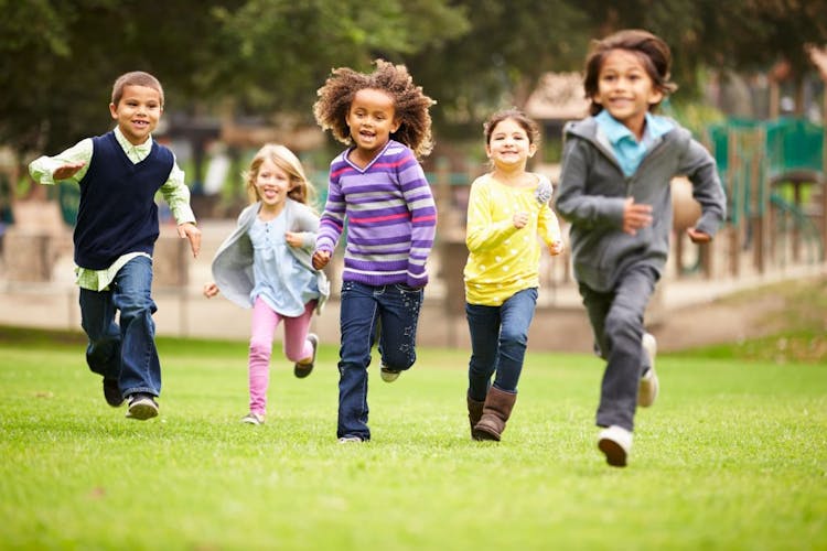 Healthy children running together at a playground