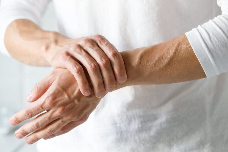An image of a man holding his wrist in pain