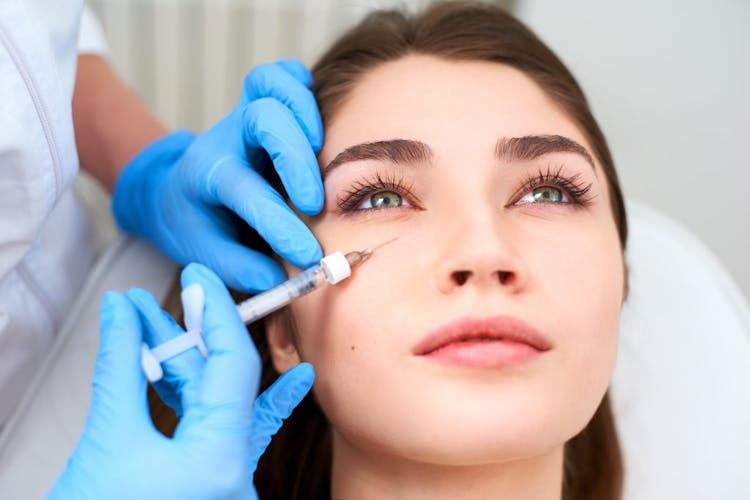 A woman getting dermal fillers under her eyes