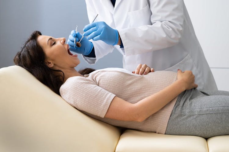 A pregnant woman during a dentist appointment 