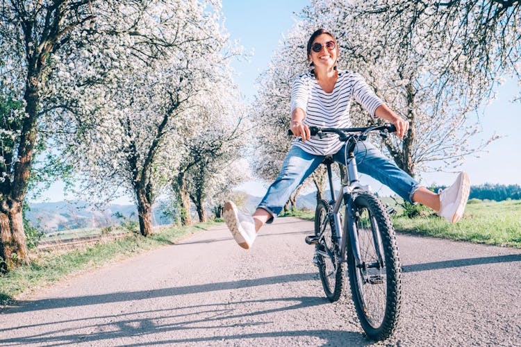 A young woman riding her bike in the Spring