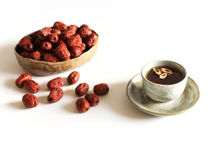 An image of red Chinese dates and tea
