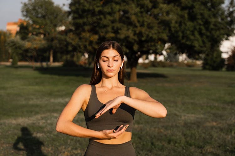 A young woman performing Qigong in the park
