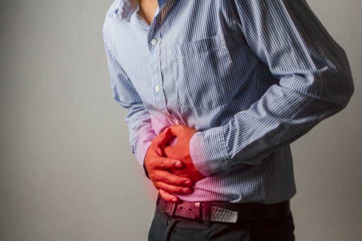 A man feels a burning sensation on his abdomen area due to gerd
