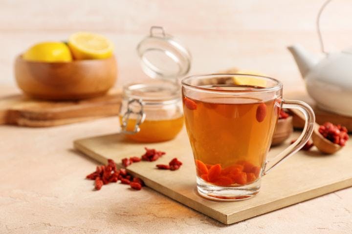 A cup of calming tea with goji berry, honey, and lemon