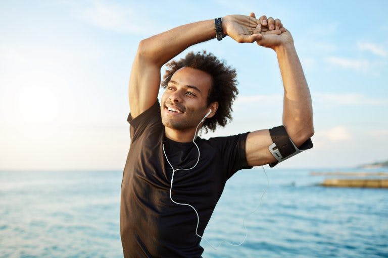 An African American young man doing exercise in the morning outdoor, feeling energized