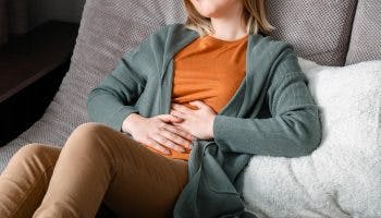 A woman touching her stomach due to period pain